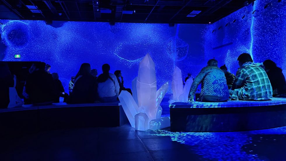 Giant light-up crystals are interspersed between benches where viewers can sit and watch the show.