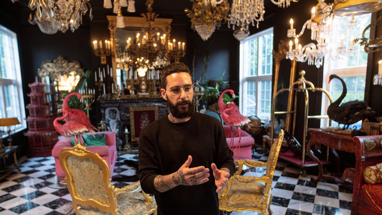 H\u00e9bert in the living with an eye-catching baggage cart visible by the window.