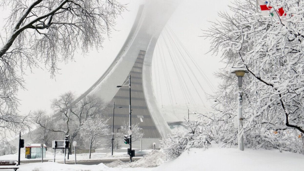 he tower of the Montreal Olympic stadium after a winter snowstorm.