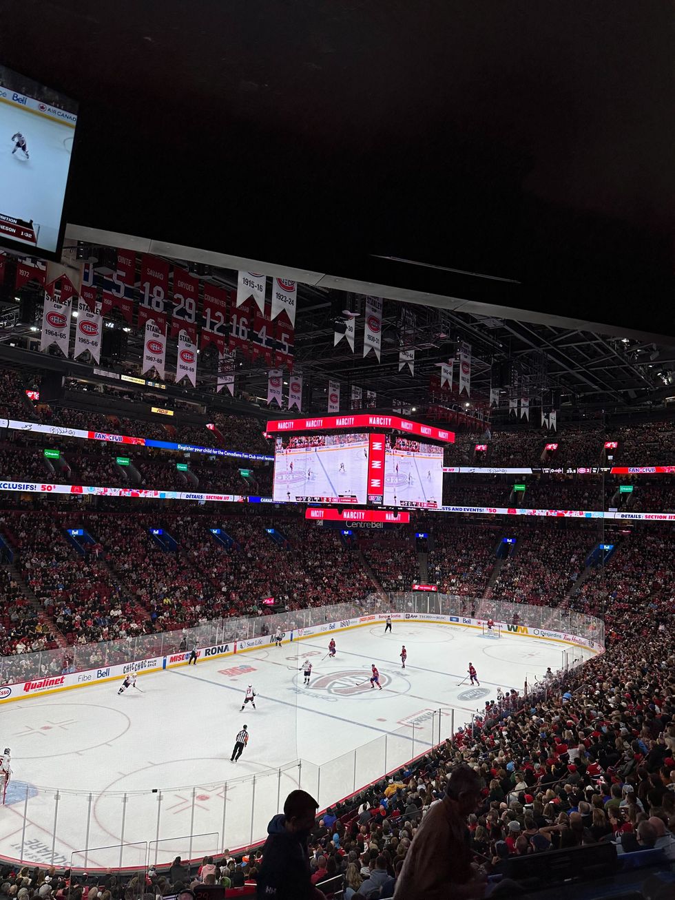 Hockey players play on the ice at Centre Bell surrounded by a stands full of fans.