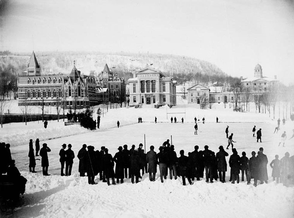 Hundreds of people watch a hockey match in front of McGill University in 1884.