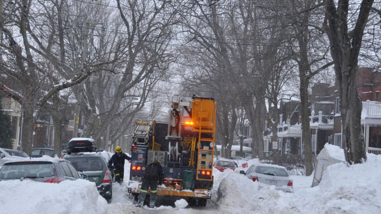 Hydro-Quebec workers restore power to a Montreal street,