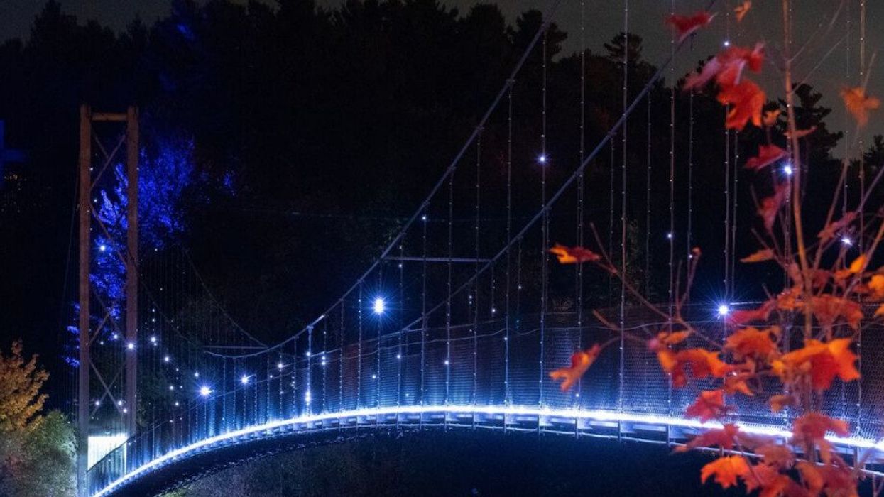 Illuminated suspension bridge at Coaticook Gorge.
