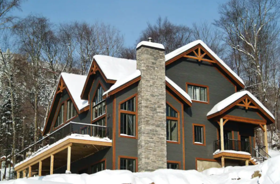 This Quebec Airbnb With A Stone Fireplace & Massive Hot Tub Is A Winter