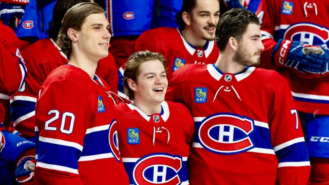 Juraj Slafkovský, Cole Caufield and Kirby Dach posing in Habs jerseys as the Montreal Canadiens take their team photo.