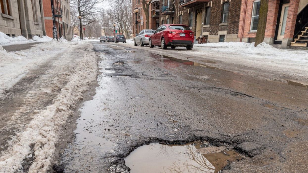 Large pothole in Montreal street in Winter.