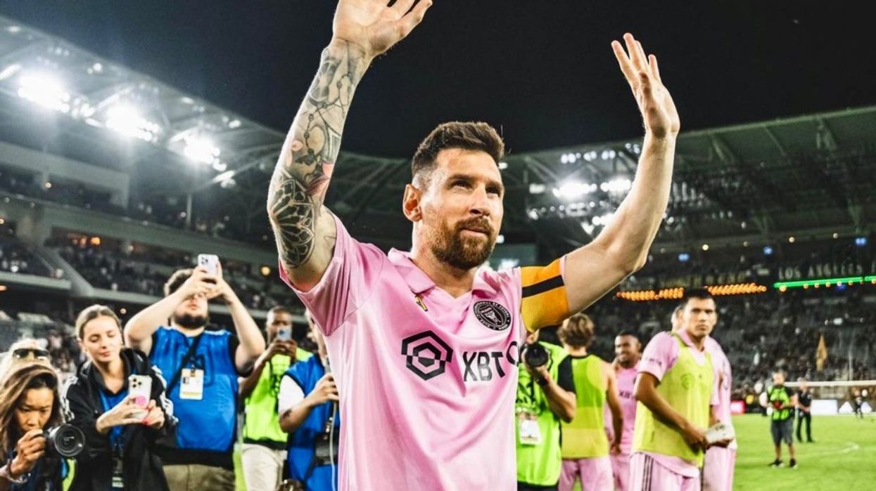 Lionel Messi waving to soccer fans.