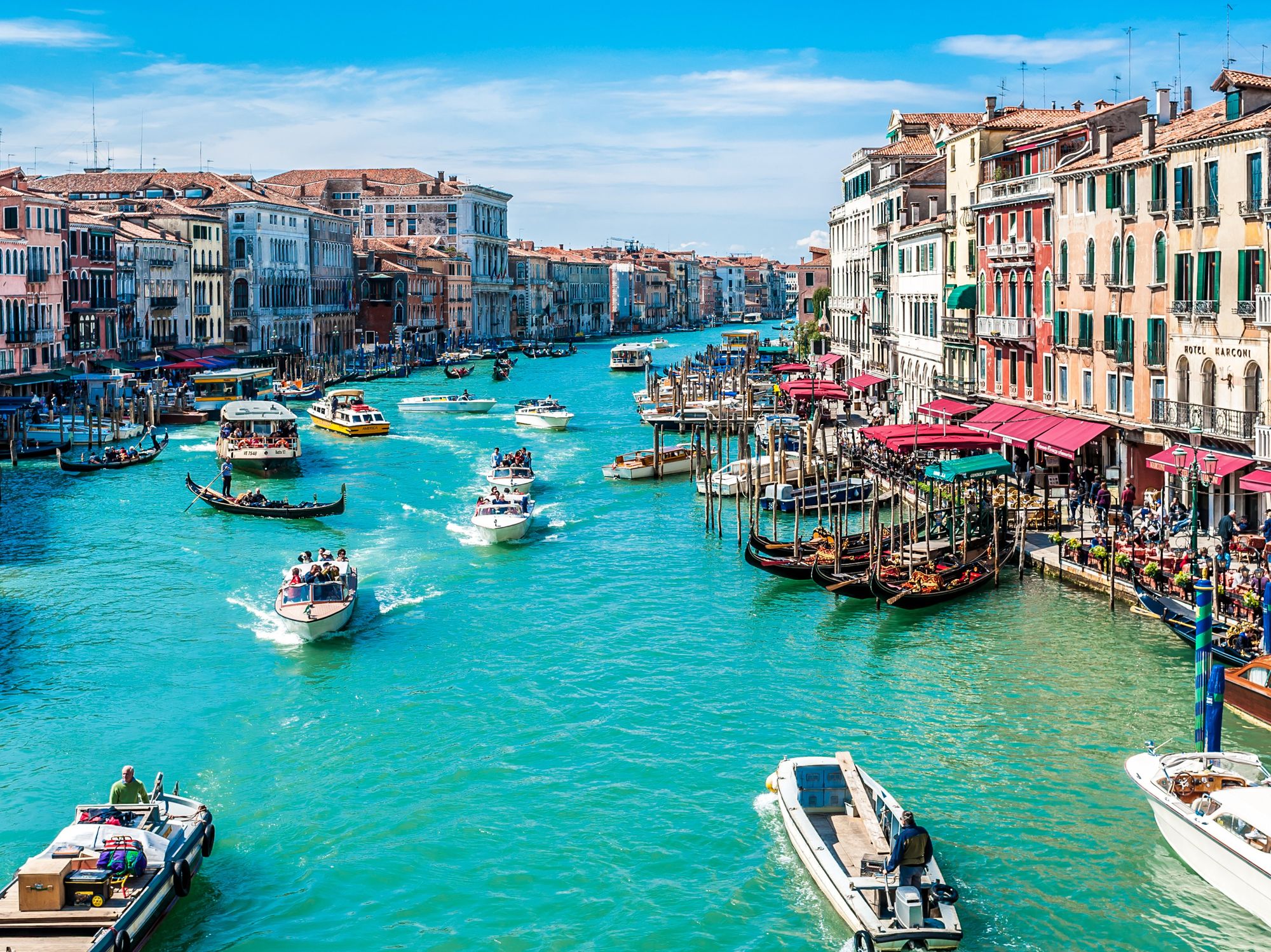 Lots of people and boats along the Canal Grande in Venice, Italy.