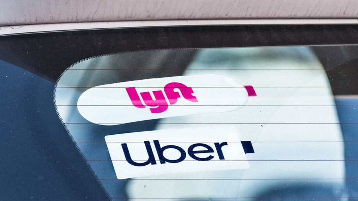 Lyft and UBER stickers on the rear window of a vehicle offering rides in San Francisco Bay Area