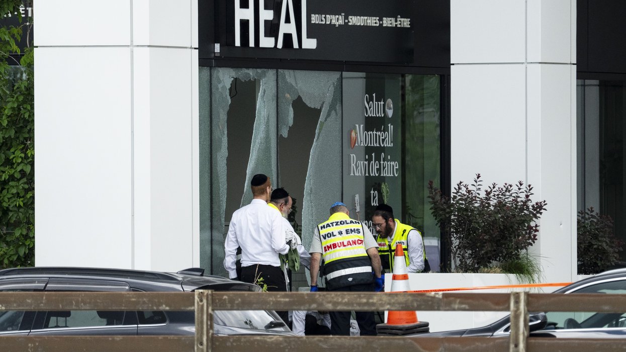 Members of the Jewish community attend the site in Montreal where a Jewish man was killed the day before