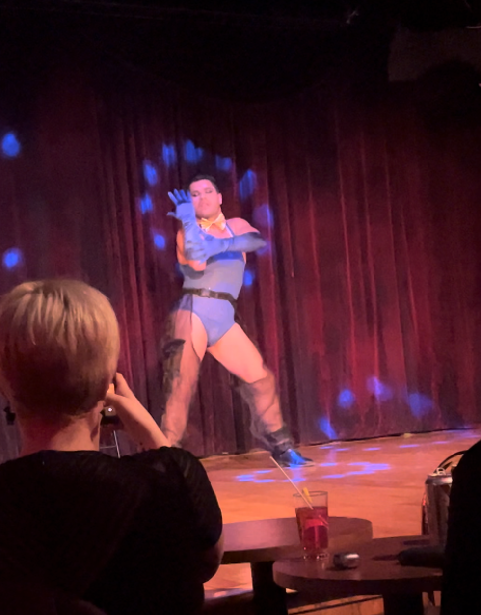 Montreal boylesque performer Petro dances in a blue leotard on stage at Cafe Cleopatra.