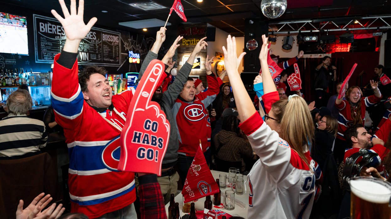 Montreal Canadiens fans waving flags and celebrating.
