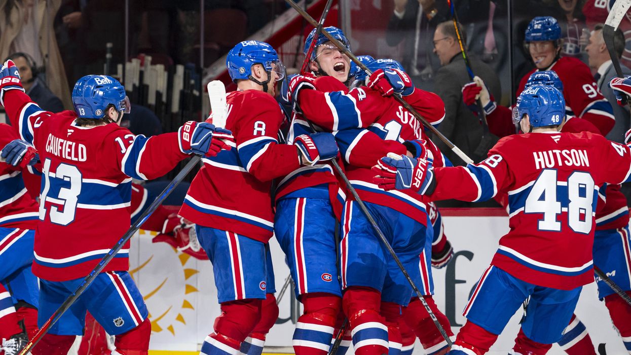 Montreal Canadiens hockey players celebrating a goal during an NHL game.