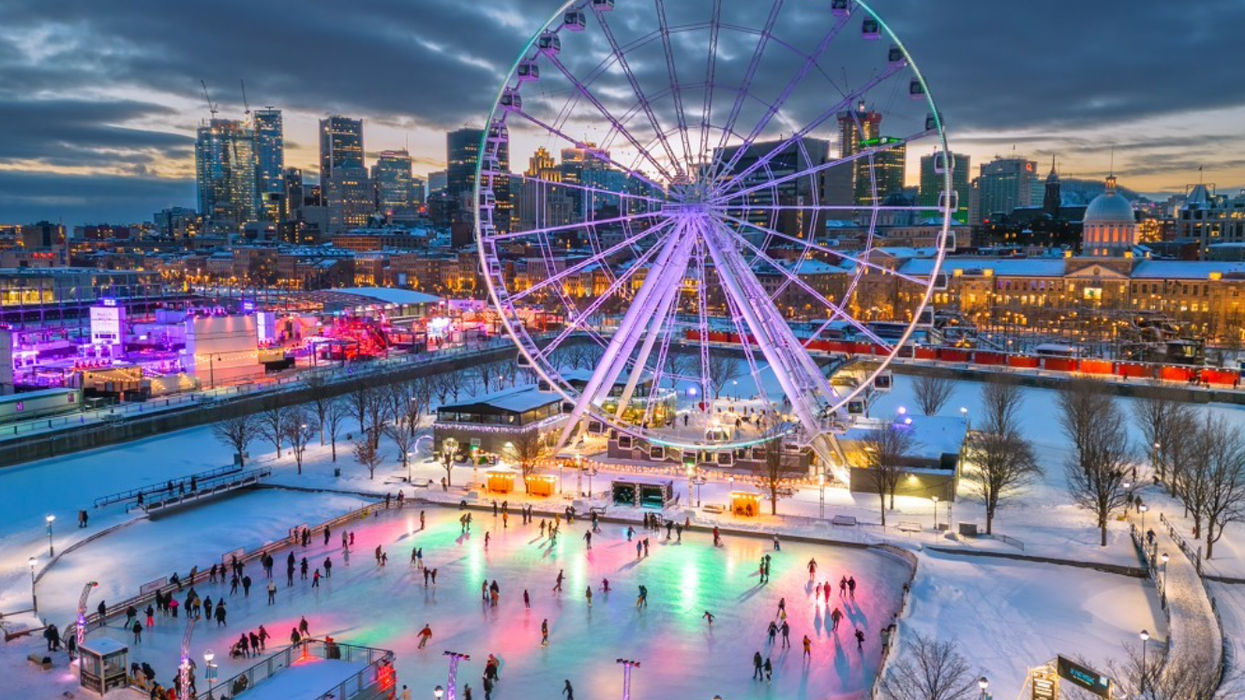 Montreal's Old Port, featuring the illuminated Grande Roue de Montréal and a colourful ice skating rink surrounded by snow and city lights.