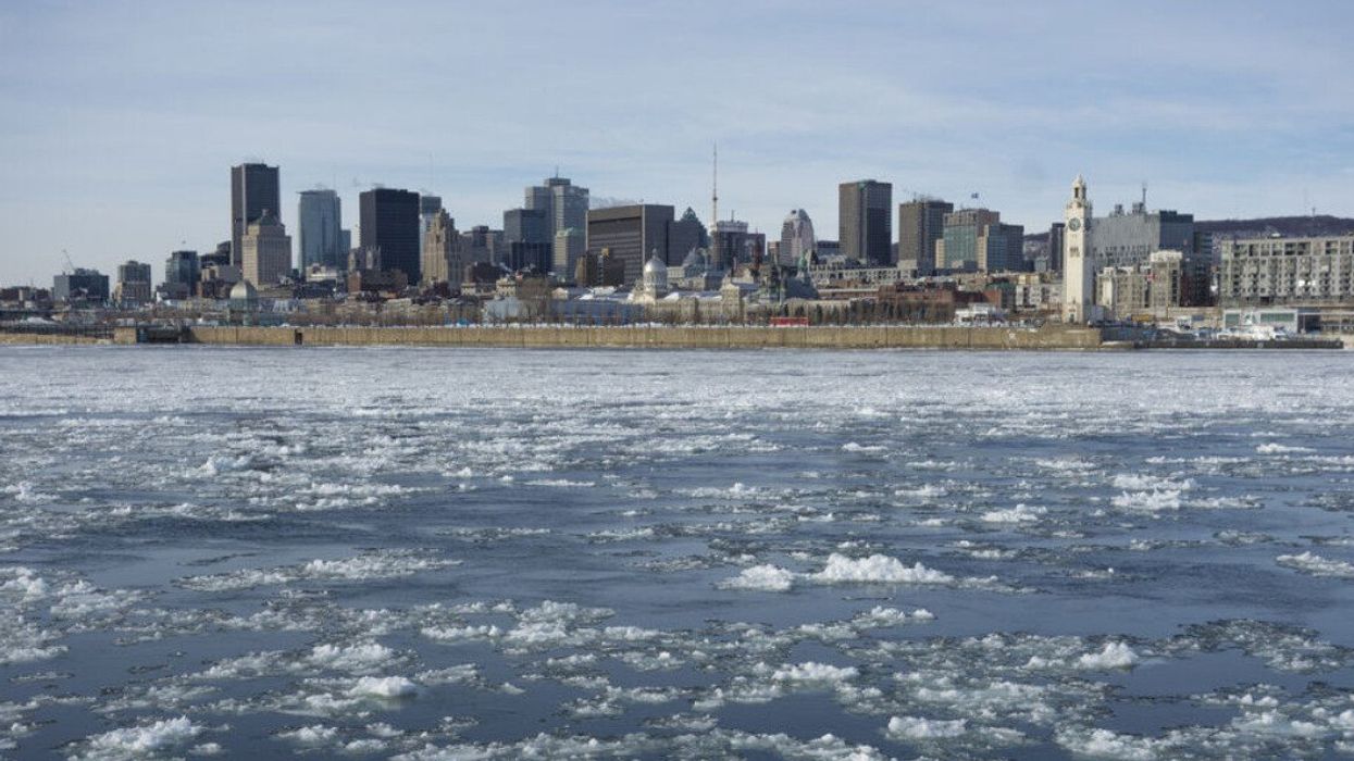 Montreal's skyline in winter, with chunks of ice floating on the Saint-Lawrence.