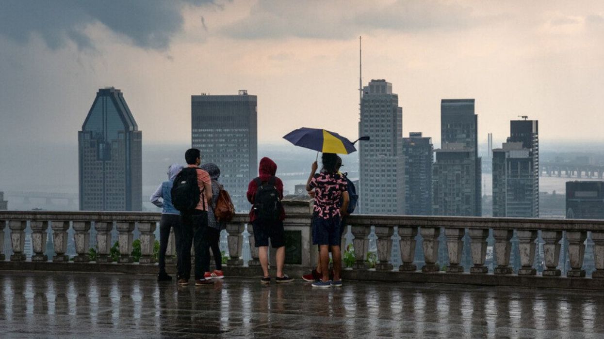Montreal skyline and skyscrapers with storm clouds and heavy rain.