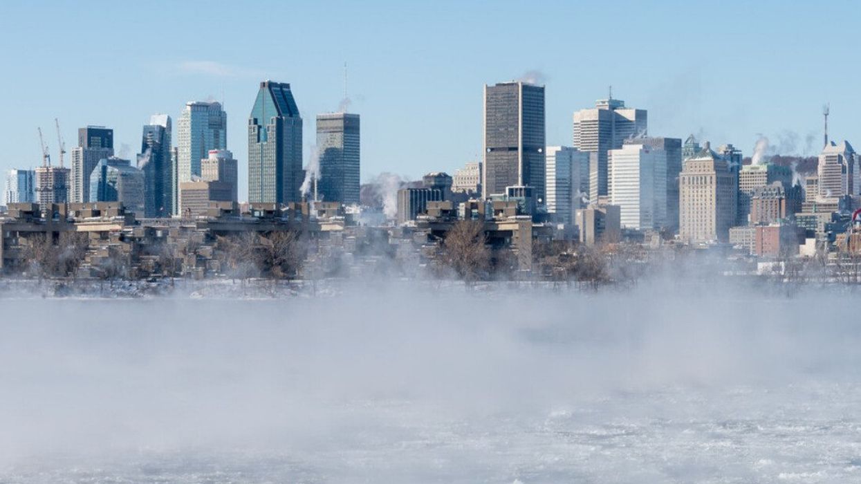 Montreal skyline in winter as ice fog rises off the St. Lawrence River.