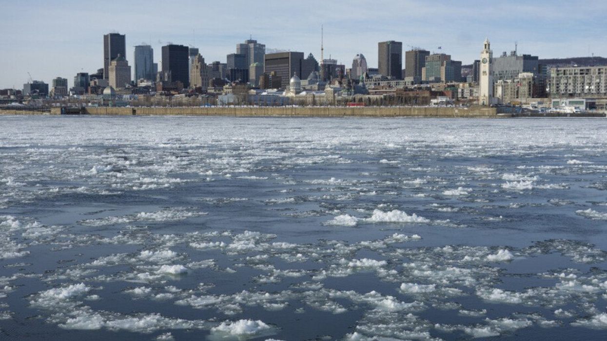 Montreal Skyline in winter, with chunks of ice floating on the Saint-Lawrence.