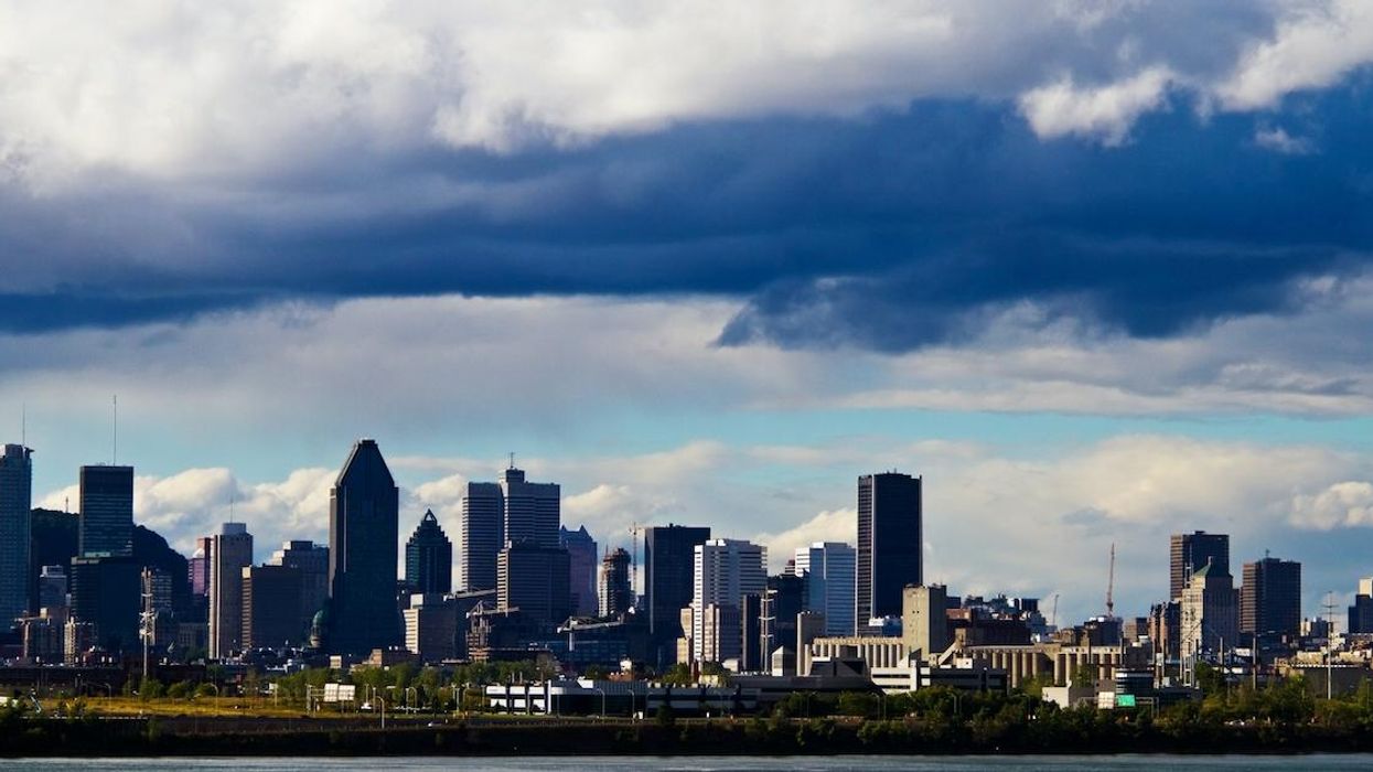 Montreal skyline with a dark cloud in the distance.