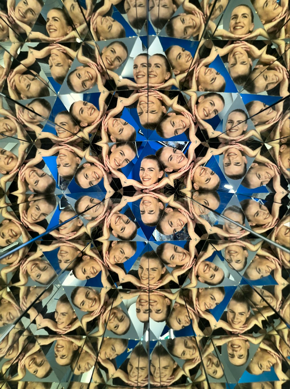 Museum of Illusions staff member Andrea Pinju\u0161i\u0107 poses in a kaleidoscope tunnel.