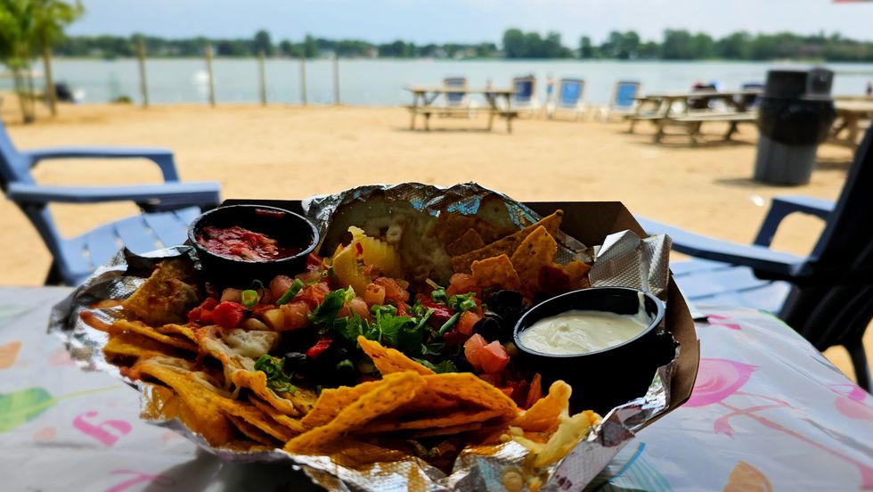 Nachos topped with salsa, olives, banana peppers and sour cream on the Super Aqua Club beach.