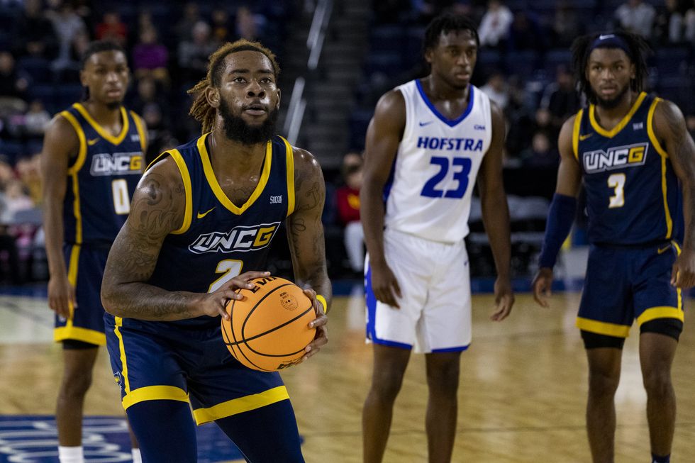 NCAA basketball players on the court.
