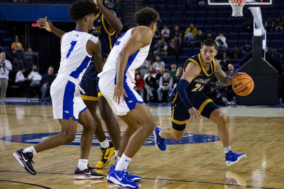 NCAA basketball players on the court.