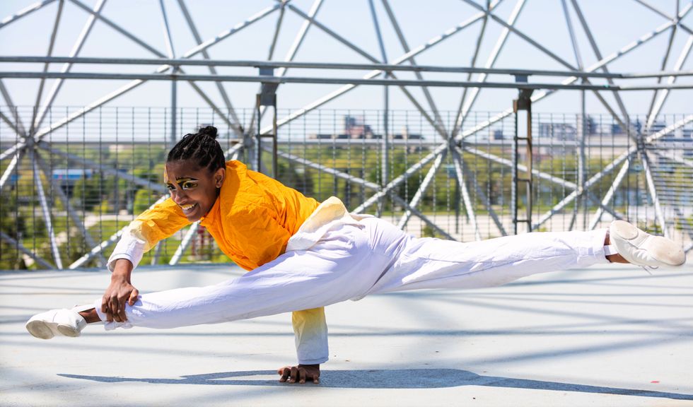 One performer does the splits while balancing on one hand atop the Biodome.