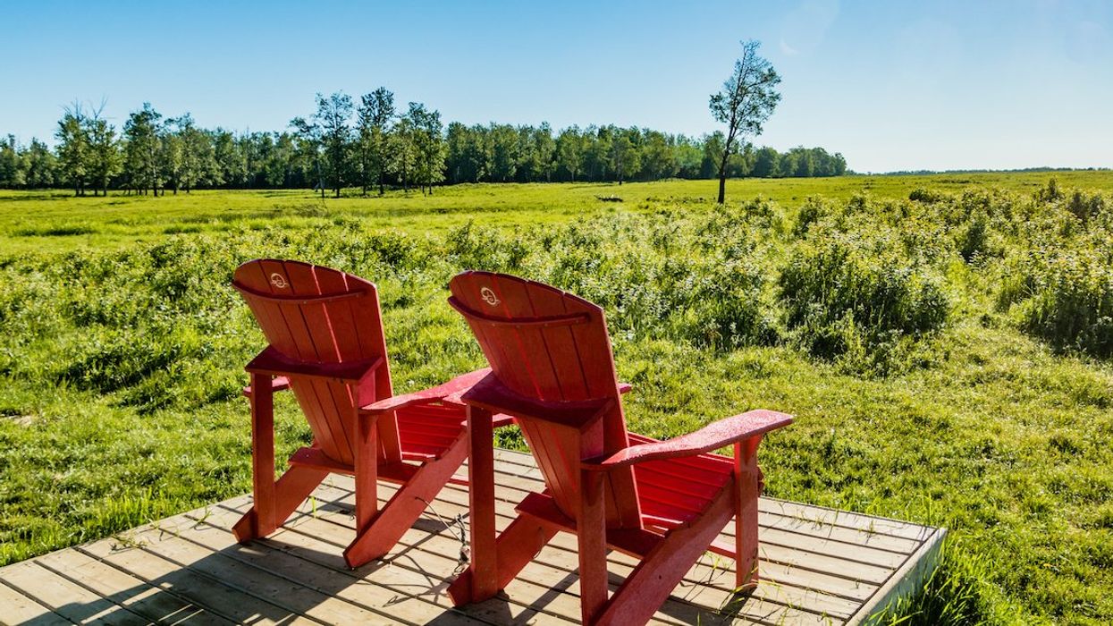Parks Canada's signature red Adirondack chairs in Elk Island National Park National Park, Alberta.