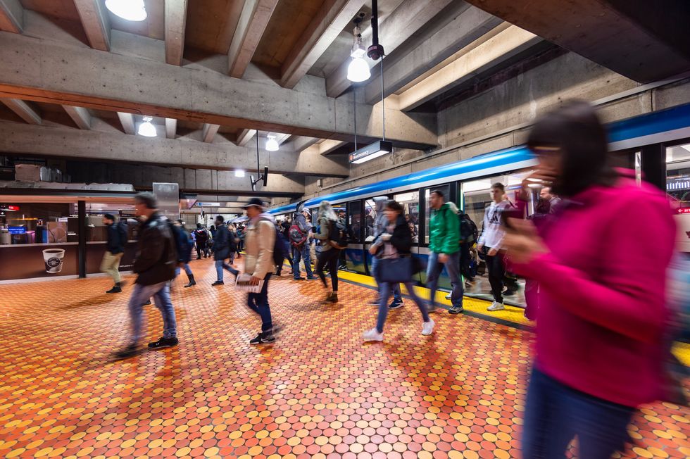 Passengers getting off a subway train at Lionel Groux station.