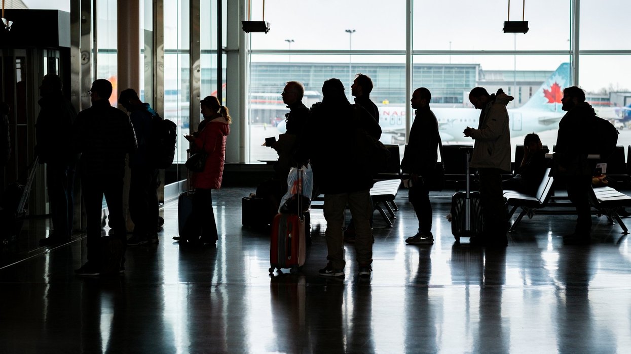 Passengers line up to board a flight at Montreal-Trudeau International Airport.