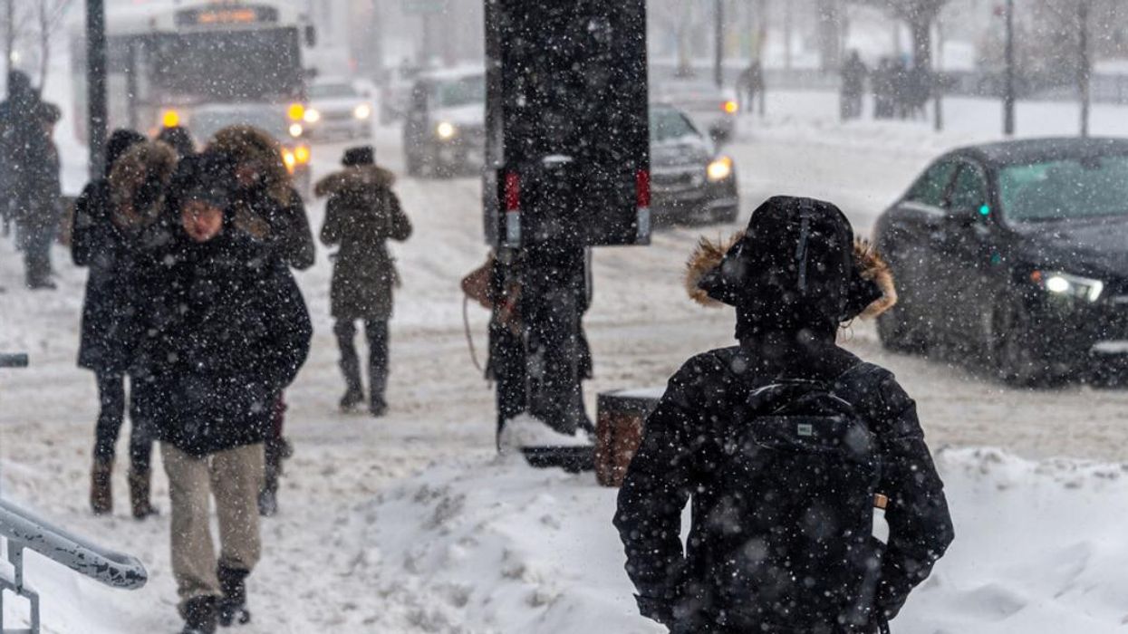 Pedestrians walk through snow in Montreal.