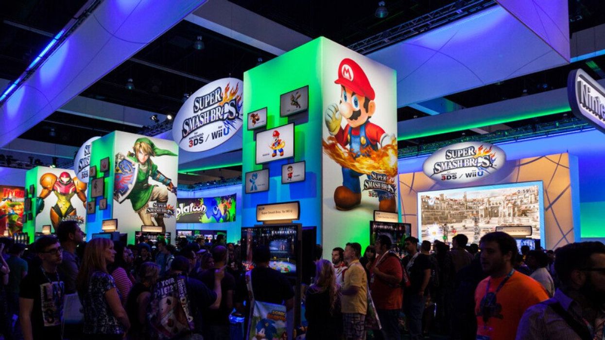 People at a Nintendo expo booth.