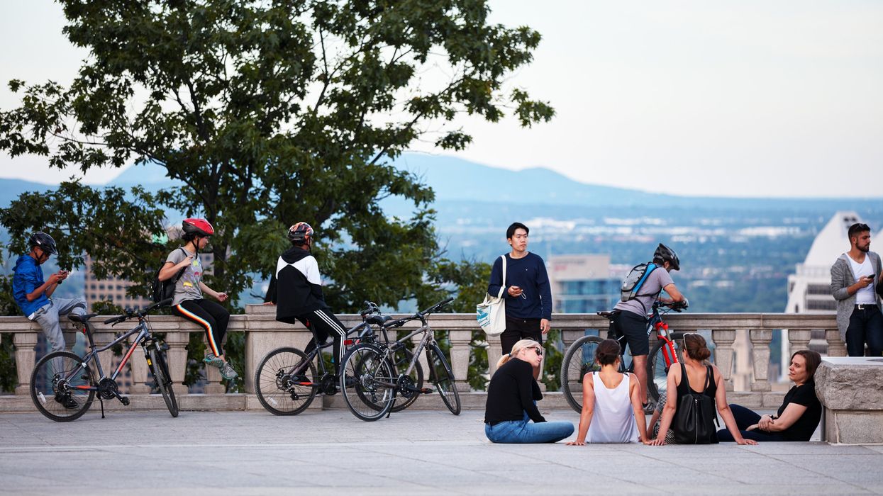 People chatting, taking selfies and watching the cityscape of Montreal.