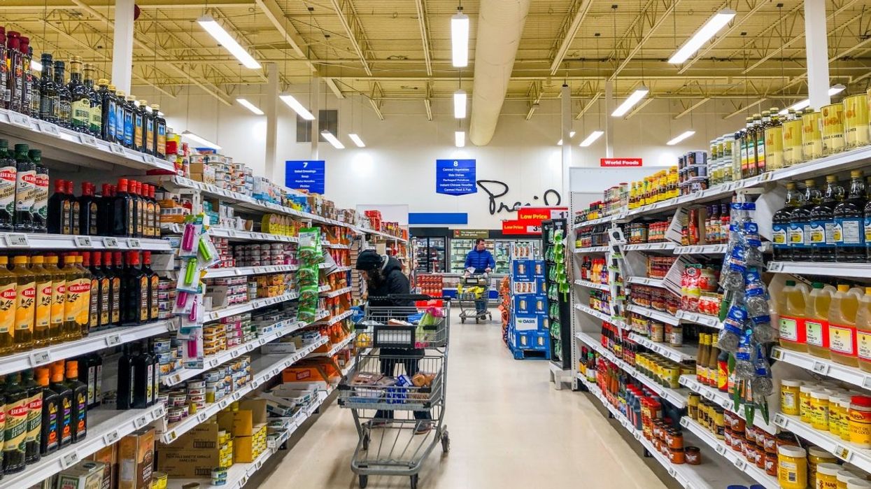 People grocery shopping at a Canadian supermarket.