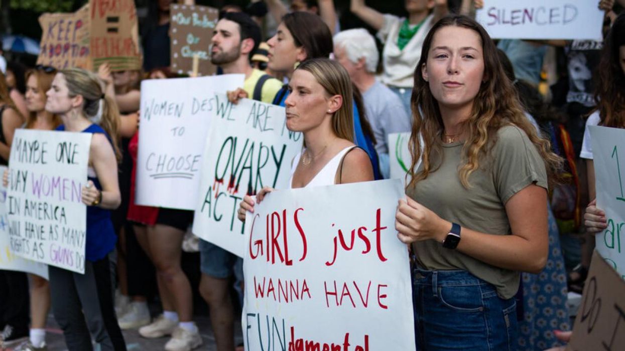 People hold up signs at a protest in New York against the Supreme Court's decision on June 24.