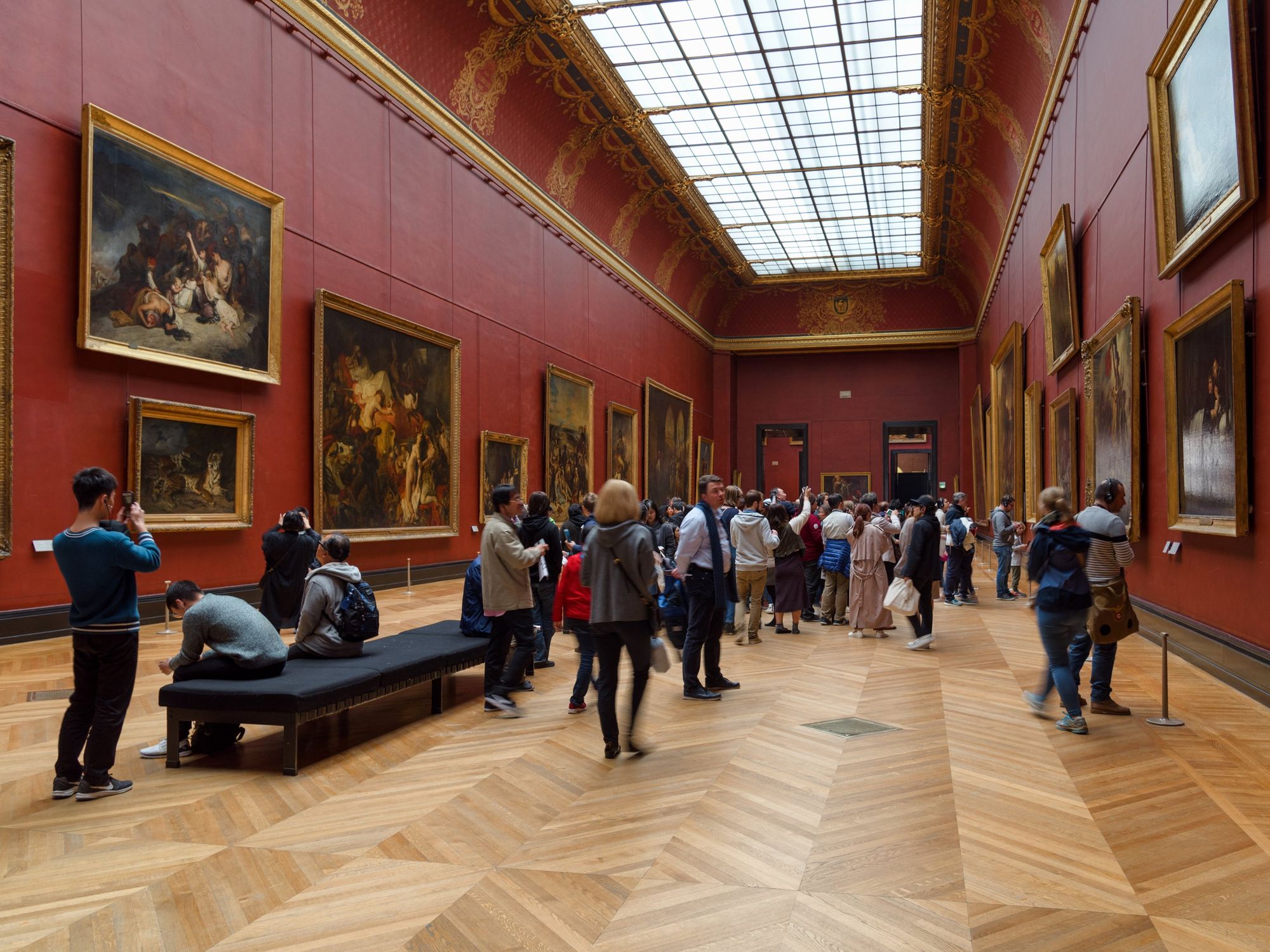 People look at art in the Louvre.