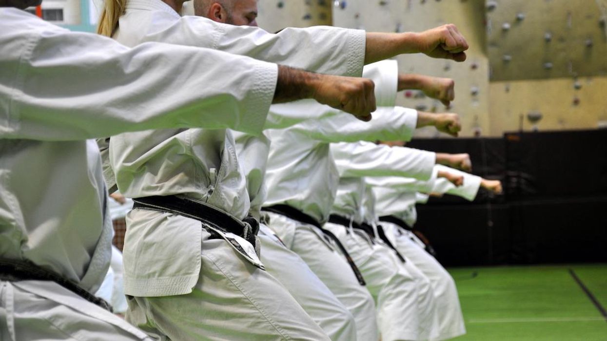 People practicing karate in a gym.