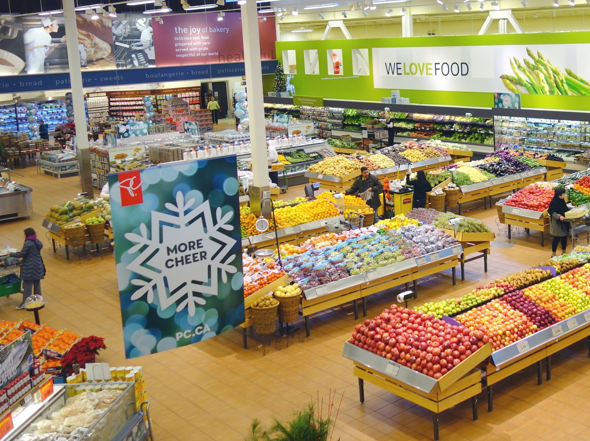 People shop in the produce section of a Loblaw's.