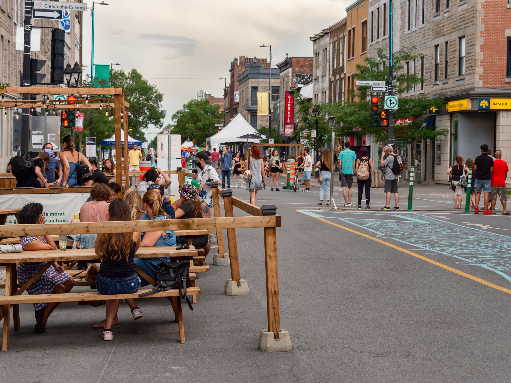People sit on a Mont-Royal terrasse while the street is closed to car traffic.