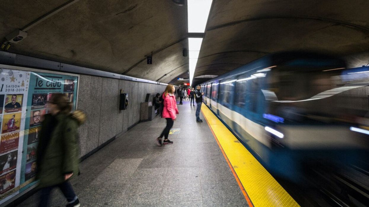 People wait for a train at the Côte-des-Neiges station.