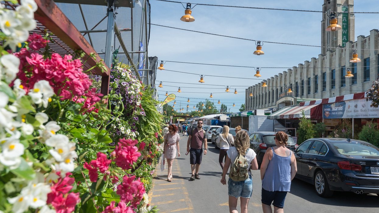 People walk around Atwater Market in Montreal.