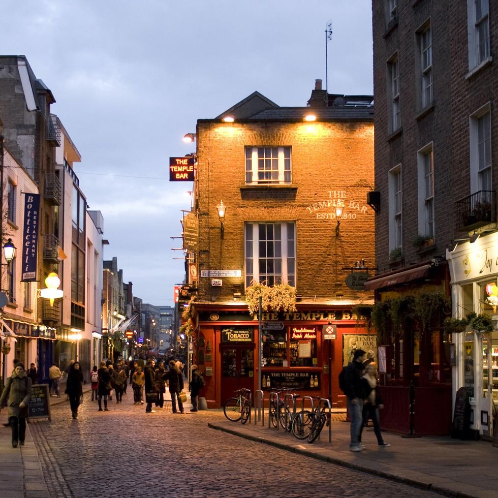 People walk around the Temple Bar district in Dublin.