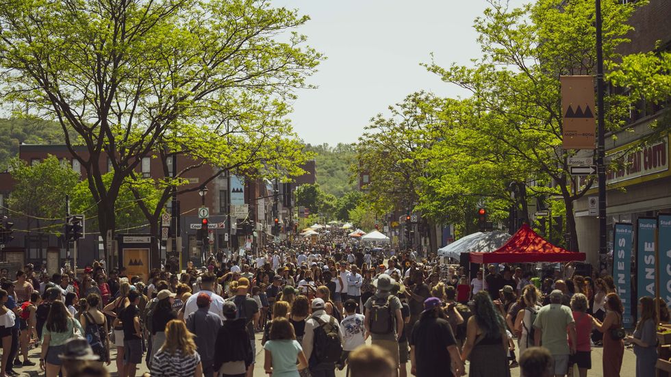 People walk down ave. Mont-Royal while it's pedestrianized.