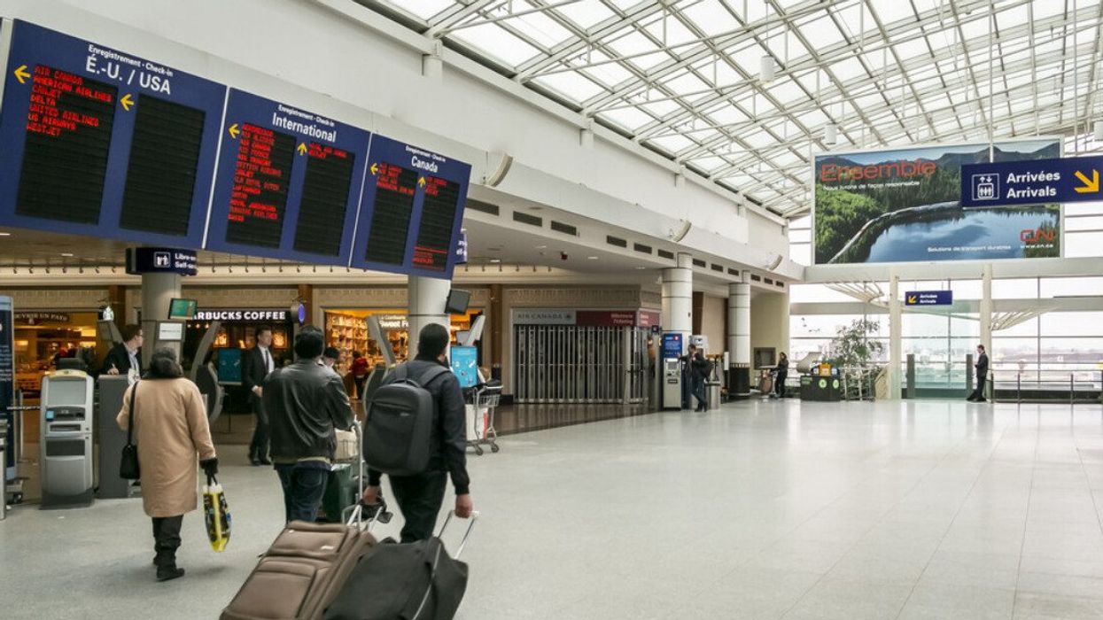 People walk through Montreal Airport.