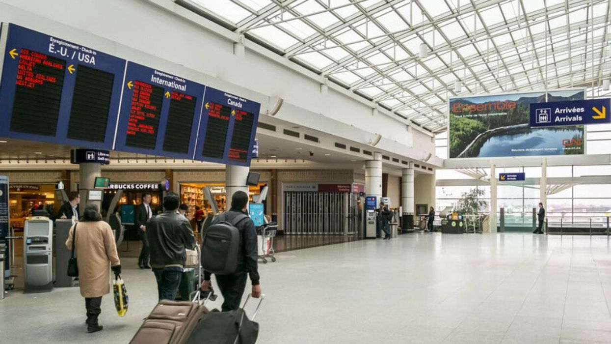 People walk through the airport in Montreal.