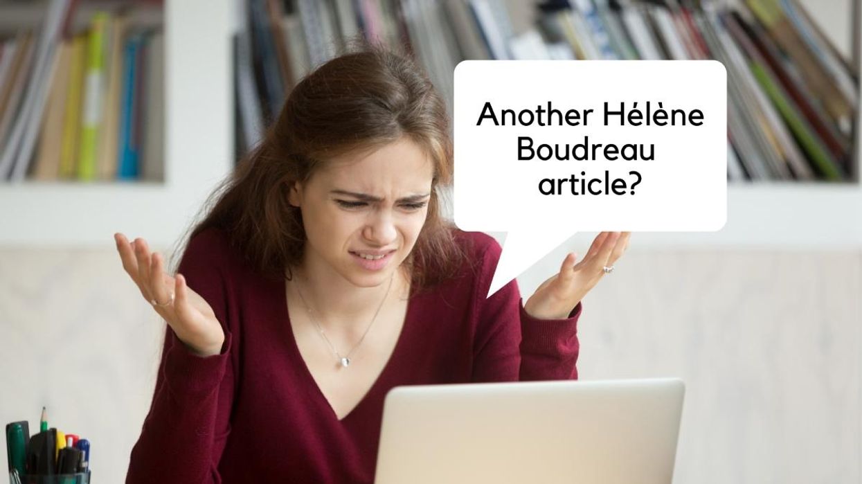 Person sitting at a desk on the computer with a very confused and angry expression.