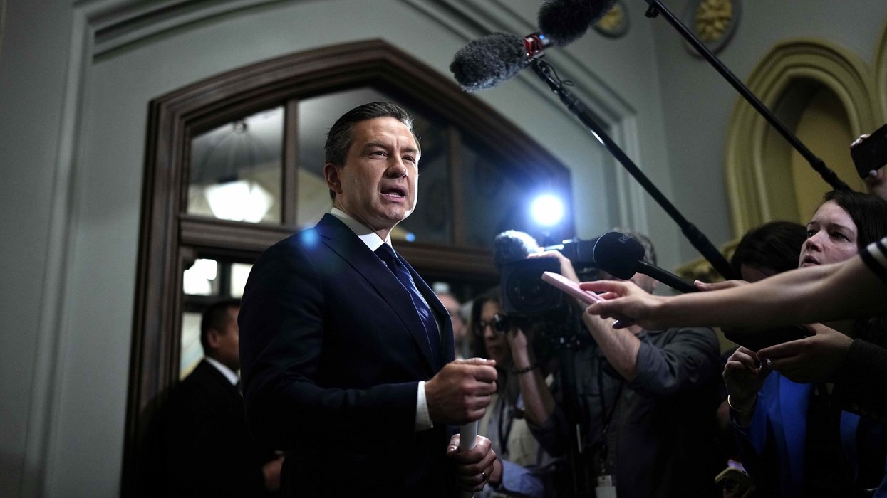 Pierre Poilievre addresses reporters in a Parliament building.