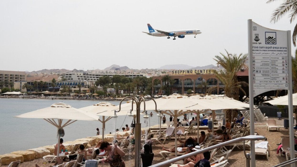 Plane above a beach in Eilat, Israel.