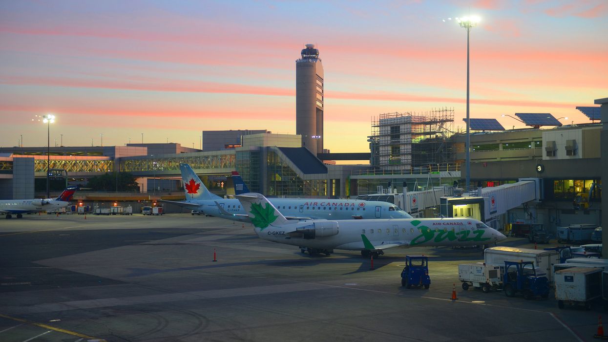Planes line up at an airport.